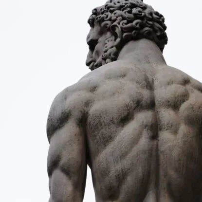 Back view of a muscular statue representing strength and recovery—symbolizing the role of nutrition in muscle repair and growth.