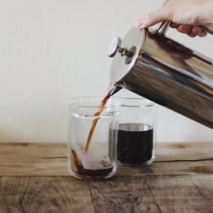 Freshly brewed coffee being poured into a glass from a French press—black coffee is a popular choice during intermittent fasting for its ability to boost energy and support fat metabolism without breaking the fast.