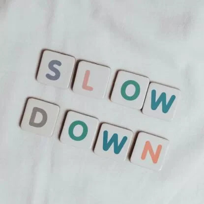 Tiles spelling out 'Slow Down'—a visual metaphor for the concept of slowing down the aging process through lifestyle, diet, and science-backed strategies.