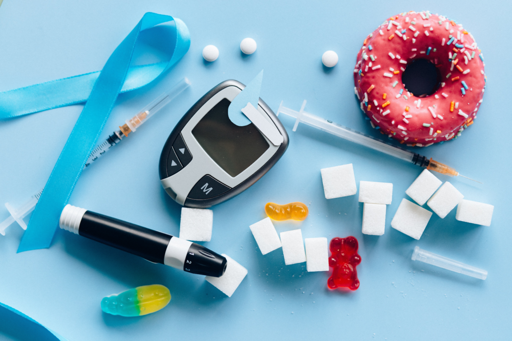 Blood pressure measuring device, a donut, sugar cubes, tablets. Diabetes, metformin, food supplements