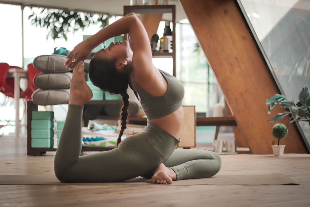 A girl practicing yoga meditation at her home.